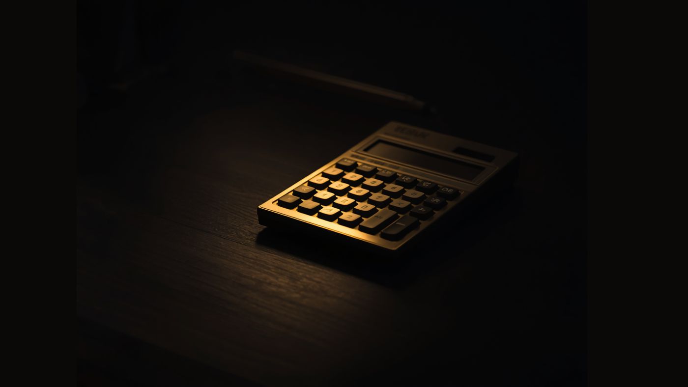 深色桌面上亮着的金色计算器。